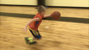 Kid dribbling a basketball
